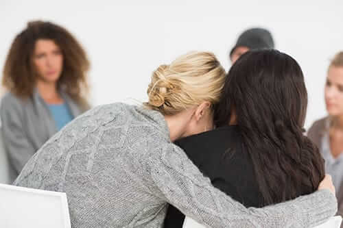 friends comforting each other in opiate addiction treatment